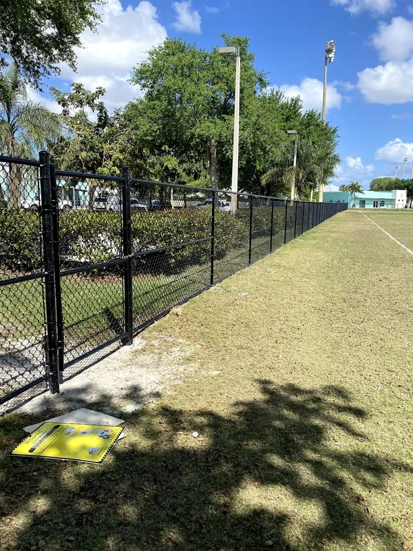Black coated chain link fence installation in Boca Del Mar neighborhood
