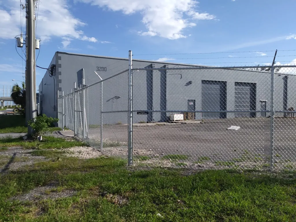 Galvanized chain link fence around commercial warehouse
